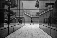 Tokyo granite reflection man walking BW