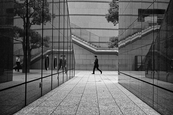 Tokyo granite reflection man walking BW