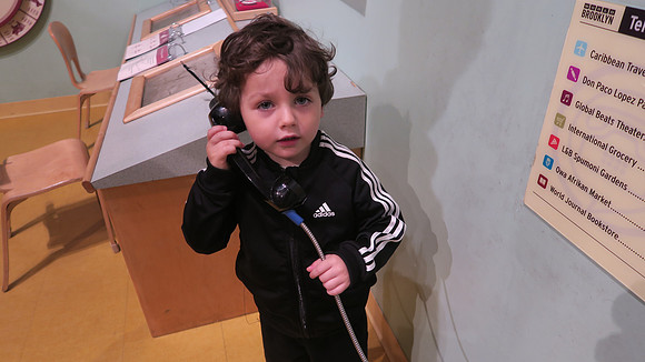 Felix on phone in Brooklyn Children's Museum