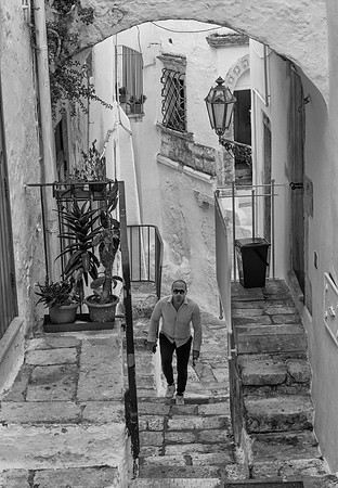 Ostuni man on steps bw