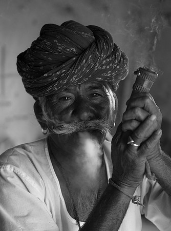 Blacksmith smoking his pipe, Manwar, Rajasthan