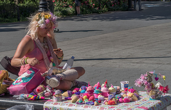 Pink pixie lady in Washington Square, New York, knitting ice creams