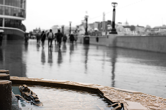Brass model of HMS Belfast in front of the real ship