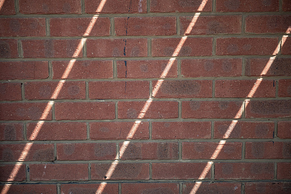 Sunlight stripes on brick