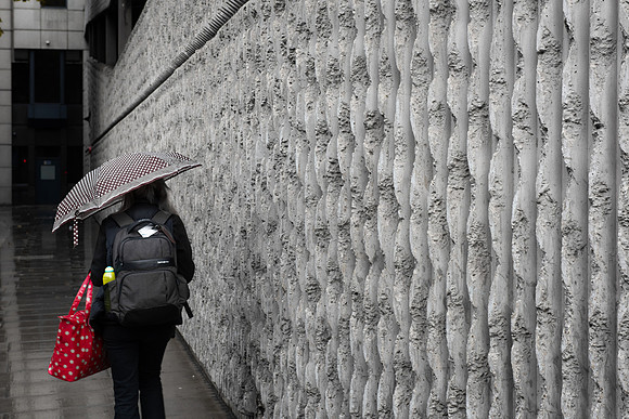 Minories concrete wall red bag
