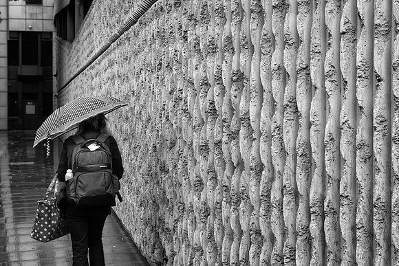 Minories concrete wall red bag bw